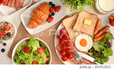 Healthy breakfast with salad bowl, croissant, a plate of American breakfast Healthy breakfast with salad bowl, croissant, a plate of American breakfast 85931621