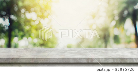 Empty concrete stone table top and Abstract blurred light bokeh and blur background of garden trees in sunlight. product display template with copy space. 85935726