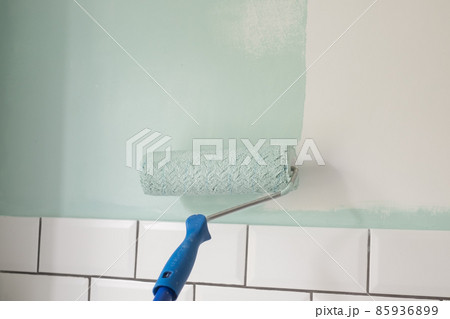 Paint rolle painting on surface wall. Renovation in house Paint rolle painting on surface wall. Renovation in house 85936899