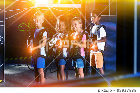 Multiracial kids posing on lasertag arena Multiracial kids posing on lasertag arena 85937838