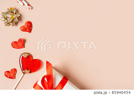 Background with gift, confetti and hearts lollipops with free space for text on pink background. Valentines day concept. Mother's Day concept. Mockup Greetings card. Copy space. Flat lay, top view 85940454
