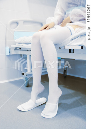 Anti-embolic surgery compression hosiery. Operating room in a hospital. Surgical equipment with operating table. Medical device for emergency patient in blue tone style. Clinic interior background. Anti-embolic surgery compression hosiery. Operating room in a hospital. Surgical equipment with operating table. Medical device for emergency patient in blue tone style. Clinic interior background. 85941267