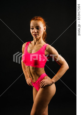 Fit strong young woman in sportswear on black and white background. Fitness gym background. Fit strong young woman in sportswear on black and white background. Fitness gym background. 85947564