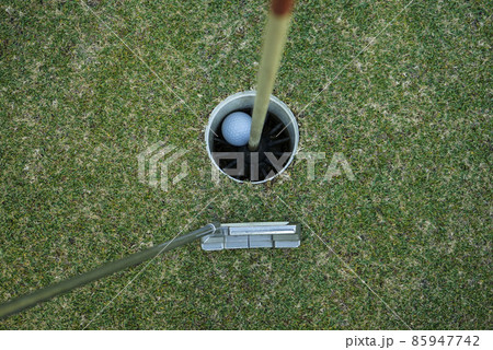 Golf ball in the hole 85947742