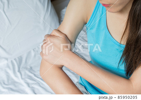 Close-up of woman holding her arm pain. Suffering painful caused by injury or overuse. Close-up of woman holding her arm pain. Suffering painful caused by injury or overuse. 85950205