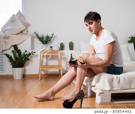Gay trying on high heels. The guy with makeup. 85954492