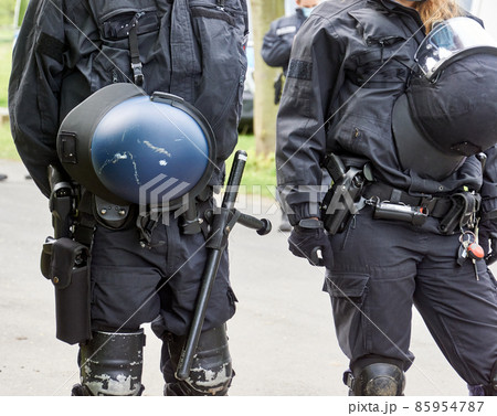 Uniformed German police officers with helmets, batons and knee pads 85954787