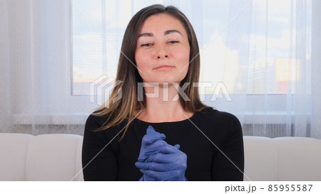 Woman in blue protective gloves using disinfectant hand wash gel to prevent virus epidemic or Woman in blue protective gloves using disinfectant hand wash gel to prevent virus epidemic or 85955587