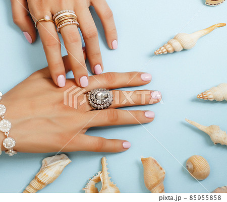 beautiful woman hands with pink manicure holding plate with pearls and sea shells, luxury jewelry concept beautiful woman hands with pink manicure holding plate with pearls and sea shells, luxury jewelry concept 85955858