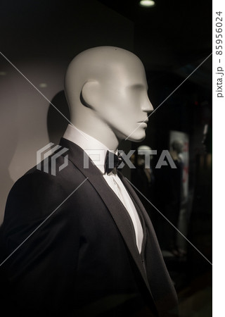 Closeup of black smoking suit on mannequin in a fashion store showroom for men 85956024