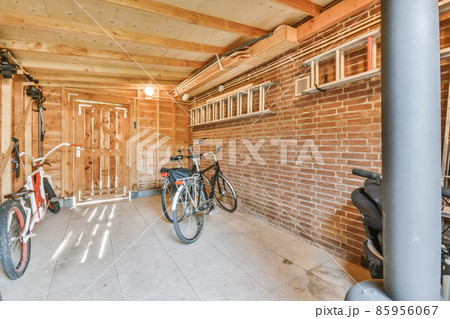 Brick room with bikes and hanging stairs Brick room with bikes and hanging stairs 85956067