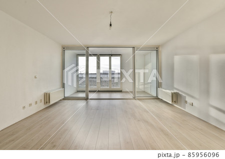A bright room with large windows on the entire wall A bright room with large windows on the entire wall 85956096