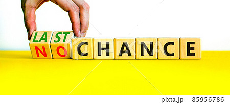 No or last chance symbol. Businessman turns wooden cubes and changes words 'no chance' to 'last chance'. Beautiful white background, copy space. Business and no or last chance concept. No or last chance symbol. Businessman turns wooden cubes and changes words 'no chance' to 'last chance'. Beautiful white background, copy space. Business and no or last chance concept. 85956786