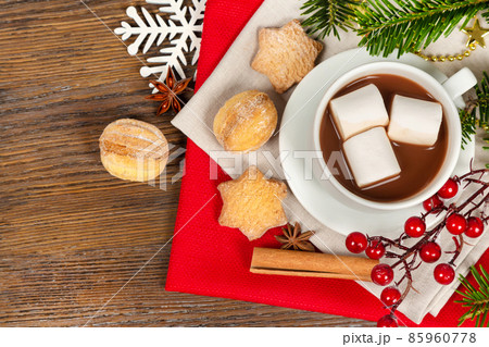 Hot cocoa drink in a white cup and homemade cookies Hot cocoa drink in a white cup and homemade cookies 85960778