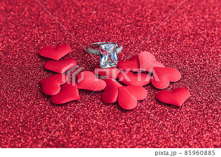 Will you marry me. Wedding ring and many red hearts on red glitter background. Engagement marriage proposal wedding concept. St. Valentine's Day postcard. Banner on valentines day 85960885