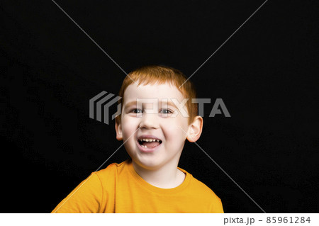 a boy with red hair smiles and laughs 85961284