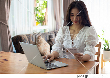 Shopping online concept.young woman holding credit card using laptop computer. Business Woman working from home 85968308