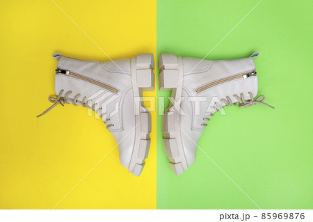 Female winter boots on high soles on a colored background, top view 85969876