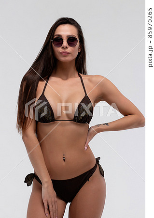 Hot sexy brunette in black bikini and sunglasses 85970265