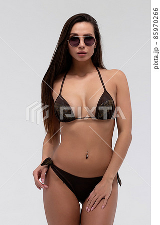 Hot sexy brunette in black bikini and sunglasses 85970266