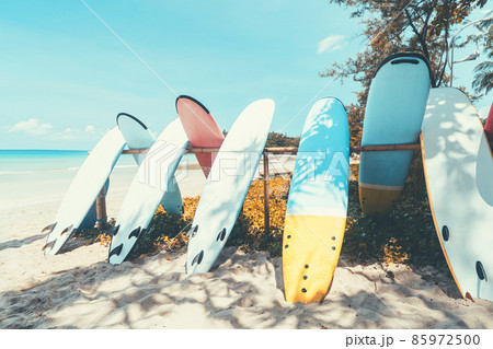 Surfboard on tropical beach with blue sky background. Summer vacation and sport extreme concept.  85972500