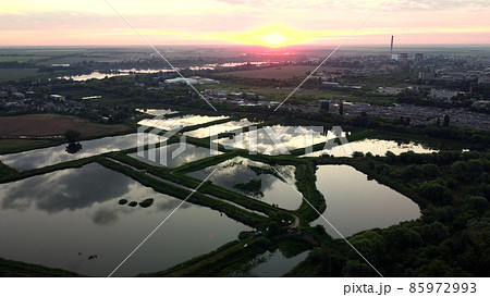 Aerial drone view flight over fish farming rates lakes. Fish Farming. 85972993
