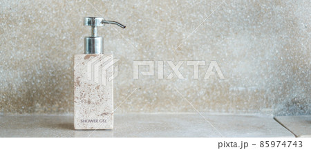 Toiletries bottles in bathroom at luxury hotel or modern home. body shower gel in ceramic ware with wall background 85974743