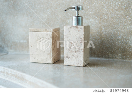 Toiletries bottles in bathroom at luxury hotel or modern home. body shower gel in ceramic ware with wall background 85974948