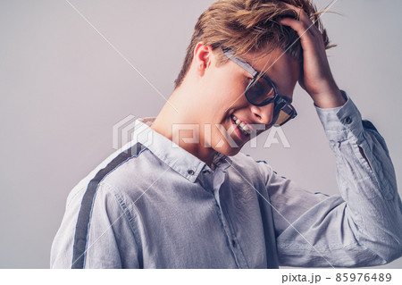 Male hairstyle concept. Portrait of handsome smiling man with stylish haircut in sunglasses. Male hairstyle concept. Portrait of handsome smiling man with stylish haircut in sunglasses. 85976489