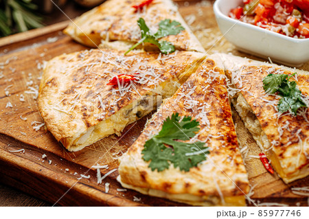 Chicken quesadilla with salsa sauce on serving board Chicken quesadilla with salsa sauce on serving board 85977746