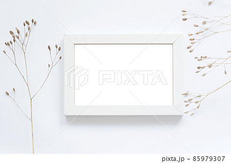 white empty photography frame and dry flowers white empty photography frame and dry flowers 85979307