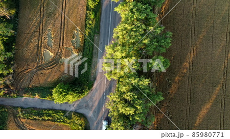 Aerial drone view flight over asphalt road with green trees Aerial drone view flight over asphalt road with green trees 85980771