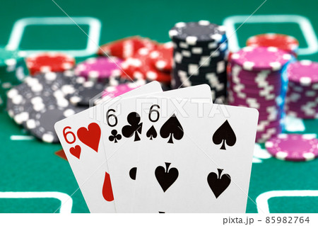 Playing cards and chips on green casino table background Playing cards and chips on green casino table background 85982764
