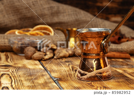 Shiny copper turk with brewed coffee on brown wooden table Shiny copper turk with brewed coffee on brown wooden table 85982952
