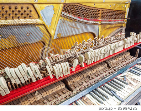 A fragment of an old broken piano with a missing wall and broken keys. Fullscreen photo A fragment of an old broken piano with a missing wall and broken keys. Fullscreen photo 85984235