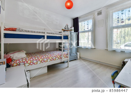 Spectacular bedroom with a bunk bed and two windows 85986447