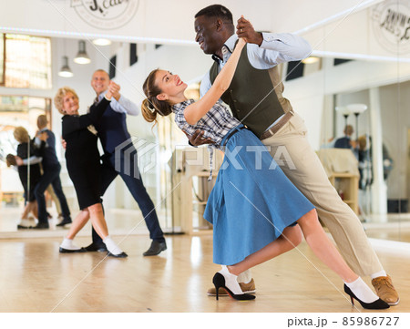 Two professional dancers practicing lindy hop in dance class Two professional dancers practicing lindy hop in dance class 85986727