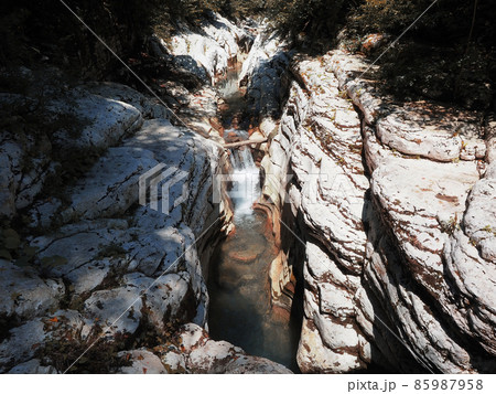 Canyon white cliffs lit by the sun with a river flowing between them Canyon white cliffs lit by the sun with a river flowing between them 85987958