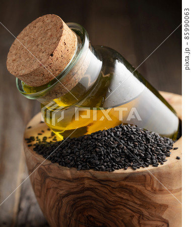 Black sesame and bottle with oil. 85990063