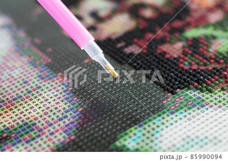 Diamond painting mosaic embroidery with pen closeup 85990094