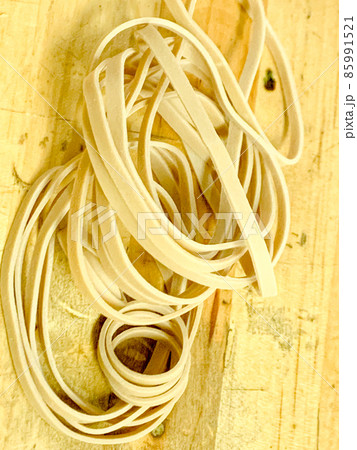 Pile of rubber bands on wooden desk close up Pile of rubber bands on wooden desk close up 85991521