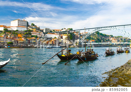 Watercolor drawing of colorful houses of old town Porto, wooden boats on Douro river close up, Porto old town view, a group of boats sailing 85992005
