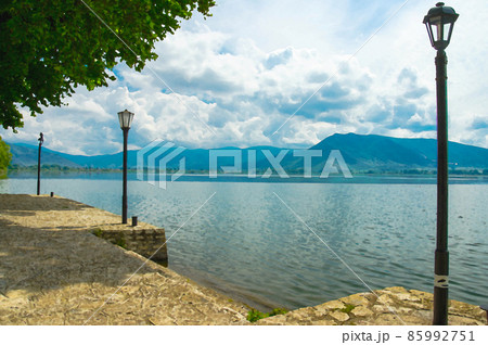 Watercolor drawing of Lampposts on the embankment promenade of Lake Orestiada 85992751