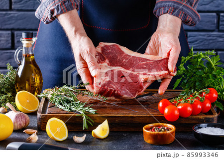 man cooking beefsteak on a kitchen, close-up 85993346