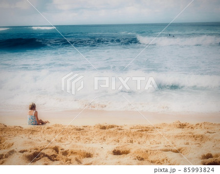 A girl sitting on the beach of Hawaii A girl sitting on the beach of Hawaii 85993824