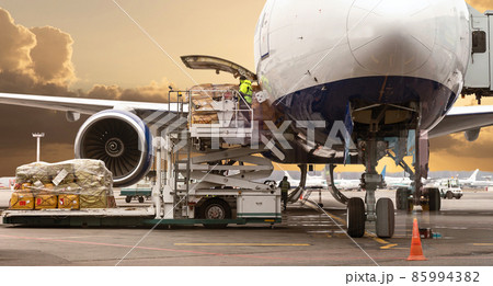 loading cargo into the aircraft before departure with nice sky 85994382
