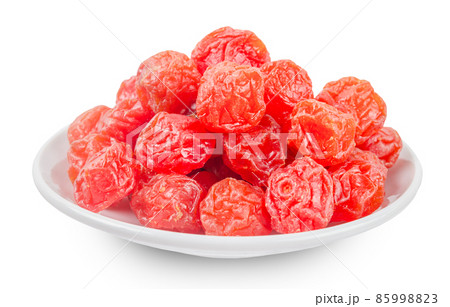 Dried red prunes fruits (Preserved fruits Chinese plum) in withe dishl isolated on white background. Dried red prunes fruits (Preserved fruits Chinese plum) in withe dishl isolated on white background. 85998823