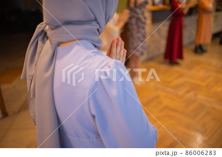 Woman putting hands up and dancing. Excited young female celebrating a victory. Muslim woman in traditional Islamic clothing - hijab. Birthday, New Year celebration concept. Woman putting hands up and dancing. Excited young female celebrating a victory. Muslim woman in traditional Islamic clothing - hijab. Birthday, New Year celebration concept. 86006283