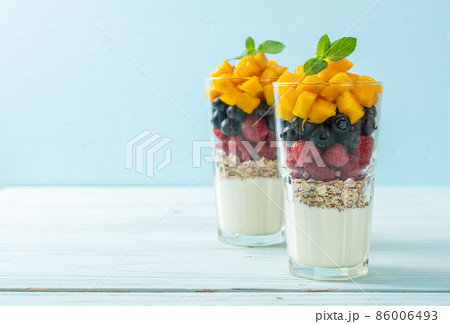 homemade mango, raspberry and blueberry with yogurt and granola homemade mango, raspberry and blueberry with yogurt and granola 86006493