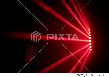 Bright red neon laser lights illuminate the darkness creating lines and triangle shapes in sci-fi effect. 86007240